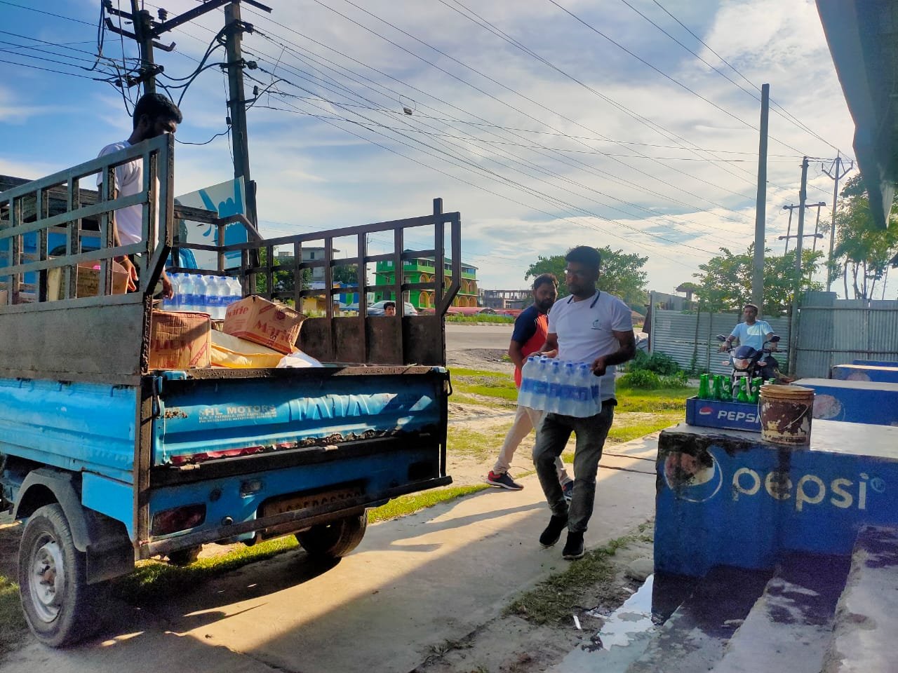 Relief supplies being unloaded for flood-affected families in Bajali, 2022