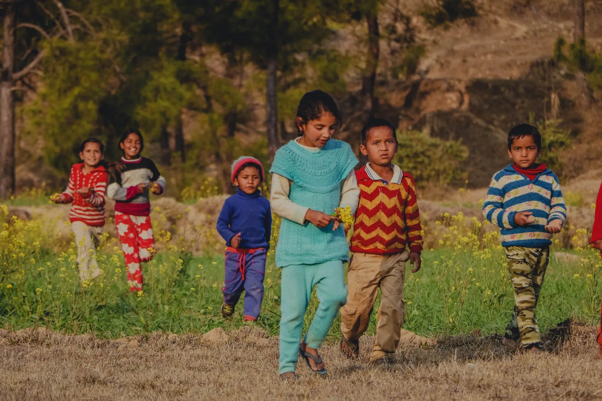 Children walking through a field