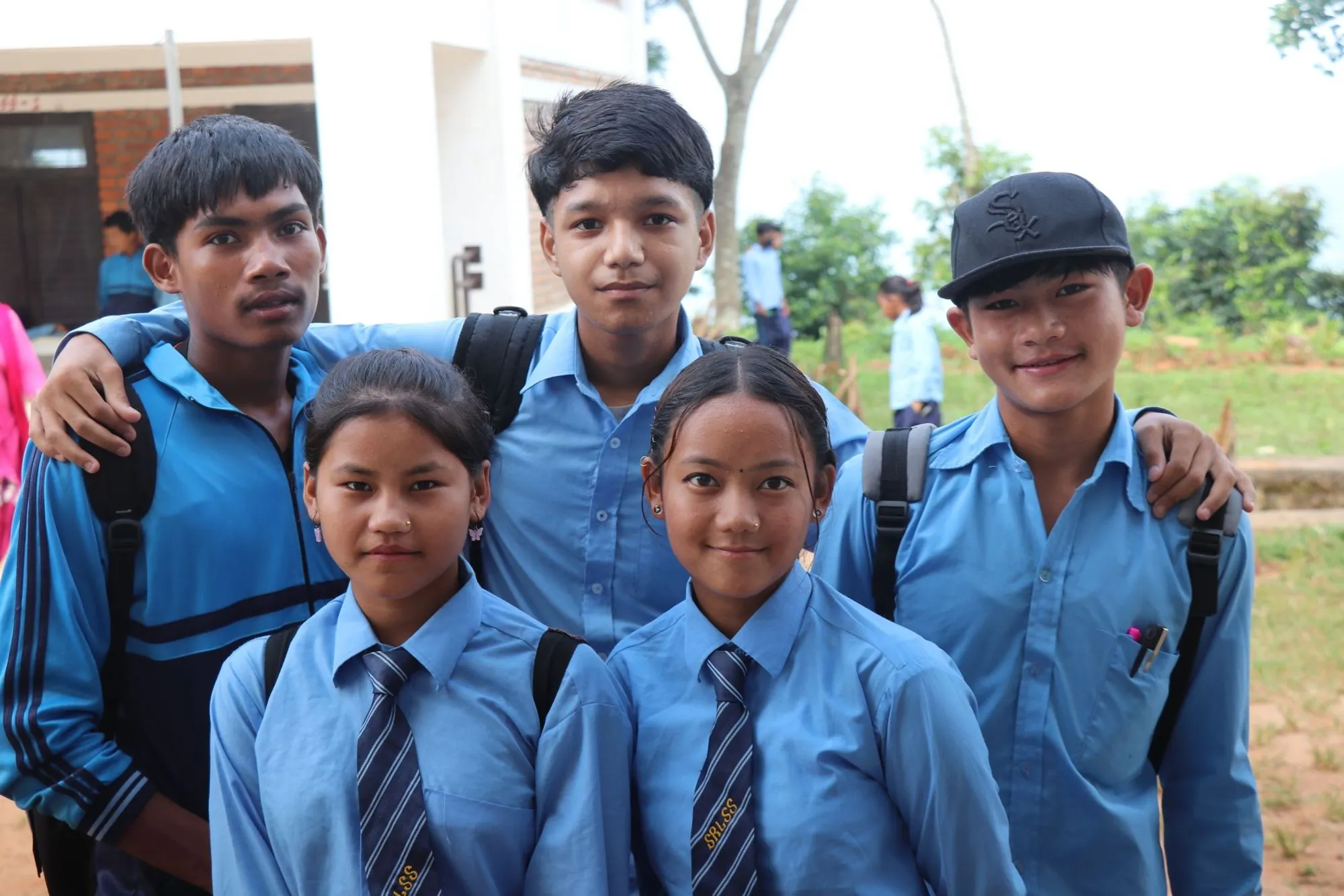 Students in school uniforms smiling