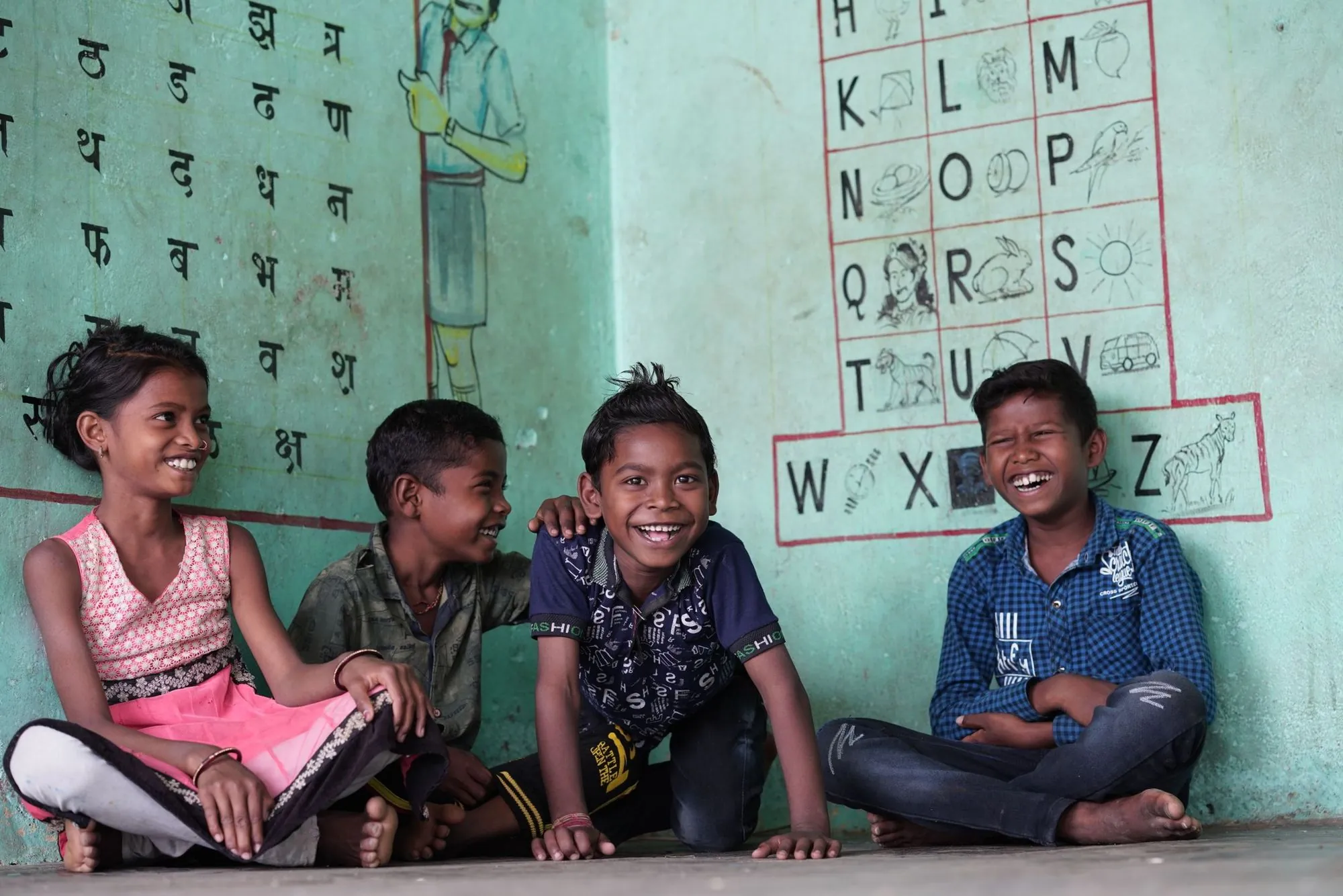 Children laughing together in a classroom in India