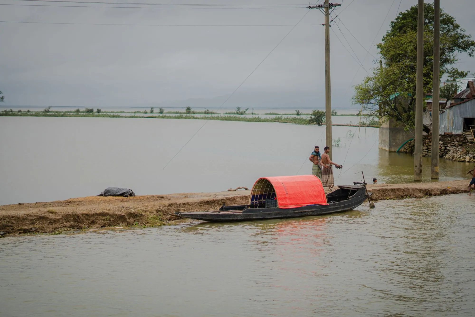 A flooded village with a wooden boat
