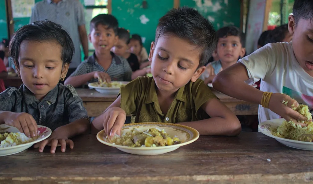Young children eating lunch together at school